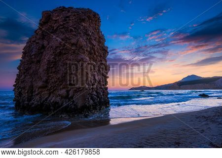 Fyriplaka beach and waves of Aegean sea on sunset, Milos island, Cyclades, Greece