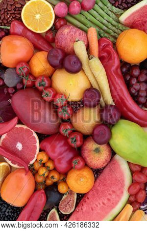 High in lycopene fresh fruit and vegetable collection for good health with immune boosting superfoods also high in anthocyanins antioxidants, dietary fibre, vitamins. Healthy eating concept. Flat lay.