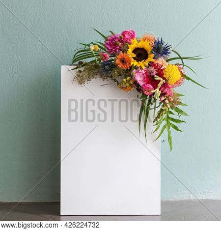 Blank white paper with a bouquet with colorful flowers