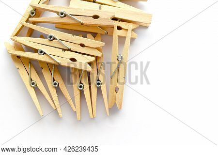 Wooden Clothes Pegs On White Background. Copy Space Is On The Right Side.