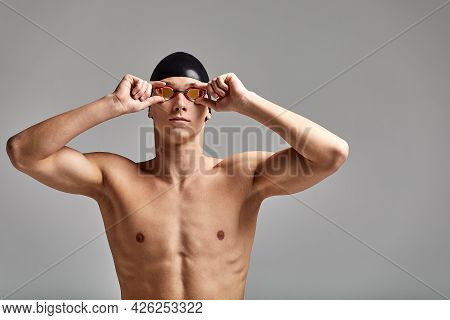 Portrait Of A Swimmer In A Cap And Mask, Half-length Portrait, Young Athlete Swimmer Wearing A Cap A