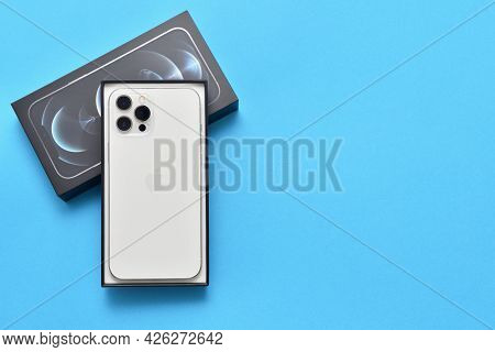 Stariy Oskol, Russia - July 5, 2021: New White Iphone 12 Pro Max In A Box On A Blue Background With 