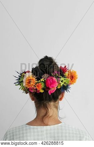Beautiful woman with a midsummer floral wreath