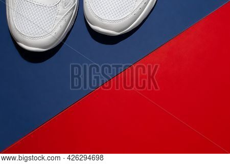 Flat Lay Front Part Of White Sneakers With Hard Summer Shadows On A Modern Background With A Diagona