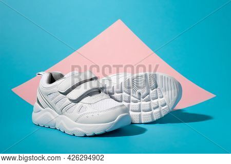 Macro Side View One White Girl Sneaker Stands In Front Of A Second Sneaker Lying On Its Side With Th