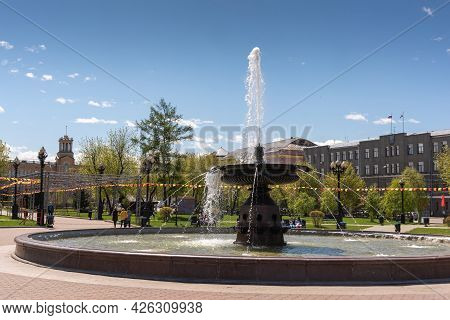 Russia, Irkutsk - May 27, 2021: Fountain And Hotel Angara In Tikhvinsky Or Kirov Square In Sunny Sum