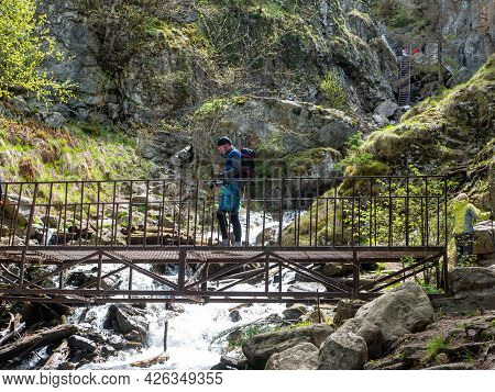 Dombay, Russia - May 18, 2021: Beautiful Waterfall Shumka Located Near Dombay. People Are Fond Of Hi