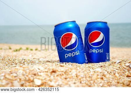 Strelkovoye, Ukraine - 23 June 2021: Illustrative Editorial Of Two Cold Pepsi Cans On The Beach. Thi