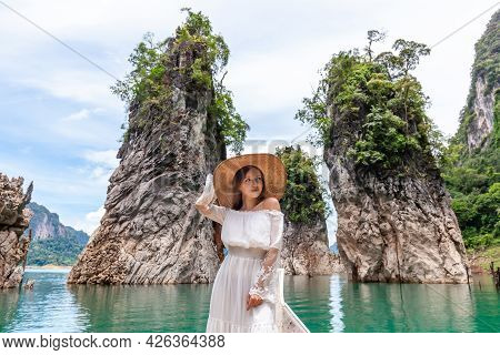 Happy Young Female Tourist In Dress And Hat At Longtail Boat Near Famous Three Rocks With Limestone 