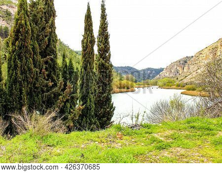 Tolosa Reservoir Surrounded By Vegetation And Mountains In Alcala Del Jucar Village, Albacete, Spain