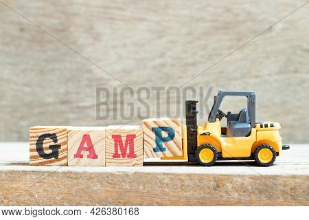 Toy Forklift Hold Letter Block P In Word Gamp (abbreviation Of Good Automated Manufacturing Practice