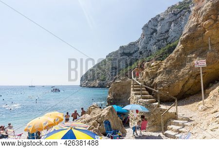 La Granadella  Spain - August 20 2016; Busy And Over-crowded Beach In Summer With Steps Cut Into Roc