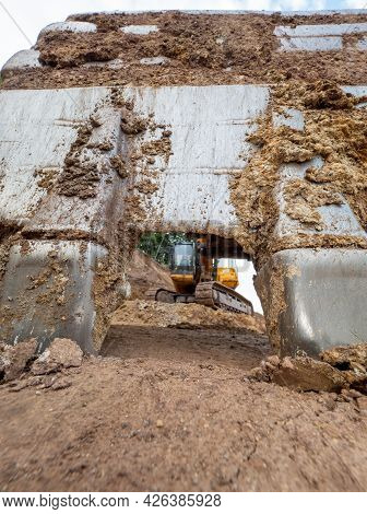 Cracked Earth Under Excavator Bucket Bite The Ground. Backhoe Bucket. Green Mind Theme