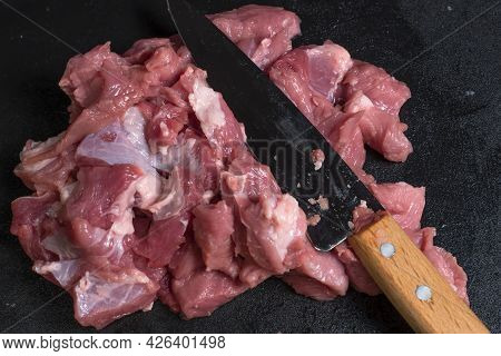 Slice The Pork Or Beef With A Knife On The Table In Close-up.preparation Of Meat Dishes And Food Pro