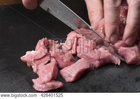 Slice The Pork Or Beef With A Knife On The Table In Close-up.preparation Of Meat Dishes And Food Pro