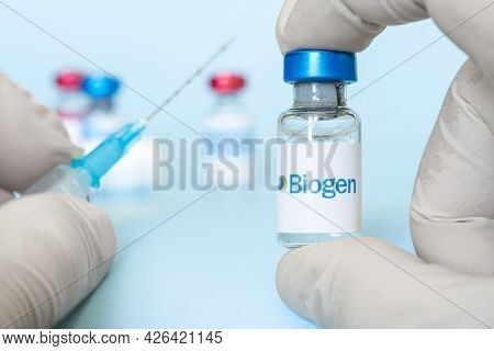 Vials Of Liquid On A White Table And The Logo Biogen, Large Pharmaceutical Company. March 15, 2021. 