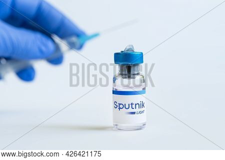 The Vaccine Sputnik Light From The Coronovirus Infection Covid 19 On A Blue Background. January 18, 