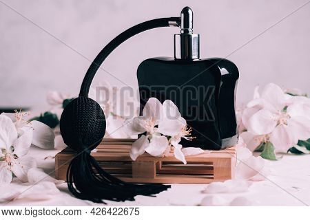 Black Bottle Eau De Toilette Or Perfume With Long Tassel Spray Pomp, On Wooden Podium In Form Of Pal