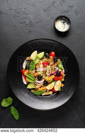 Whole Grain Pasta With Vegetables On A White Plate On Black Slate, Stone Or Concrete Background. Top