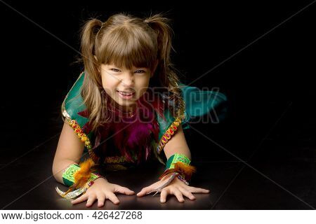 Pretty Little Girl Crawling On Floor. Portrait Of Beautiful Preteen Girl Dressed Bright Ethnic Costu