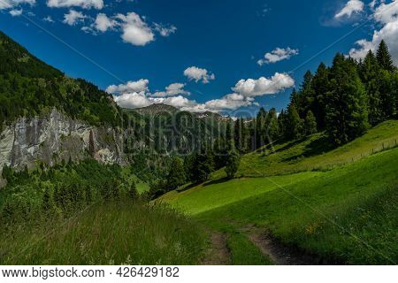 Summer Valley With Grossarler Ache Small River And Blue Cloudy Sky
