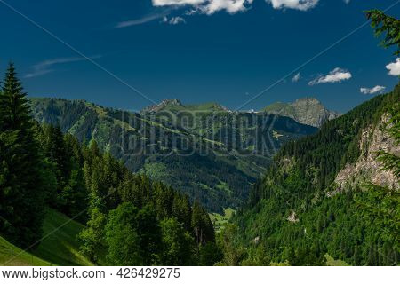 Summer Valley With Grossarler Ache Small River And Blue Cloudy Sky