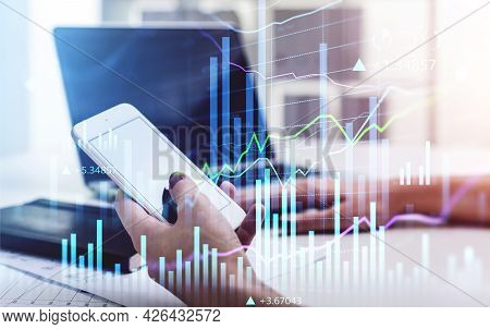 Businesswoman Hold Smartphone To Check Stock Market Rates To Predict Behavior. Hologram Charts. Busi