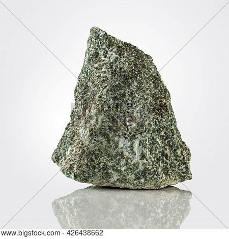 A Rough, Untreated Piece Of Jadeite On A Light Background