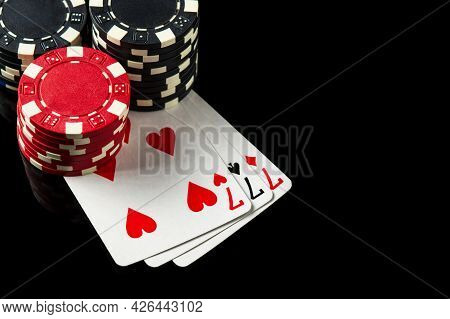 Poker Game With Three Of A Kind Or Set Combination. Chips And Cards On The Black Table In Poker Club