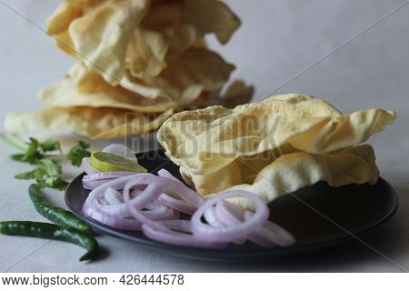 A Papadum Also Called Papad Is A Thin, Crisp, Round Flatbread From India. It Is Made By Deep Frying 