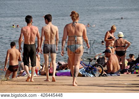 Moscow, Russia - July 2021: People Going To Swim In Moscow River In Strogino. Hot Weather, Tattooed 