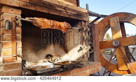 Spit Roasted Lambs, Traditional Way Of Roasting Lambs On A Rotisserie Spit In Bulgaria. Cheverme..