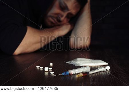 Overdosed Man At Table, Focus On Different Drugs
