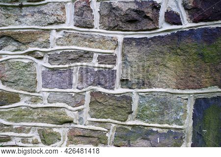 Pennsylvania Farmhouse Stone Wall Background. Vibrant Purple, Blue And Green Fieldstone, Masonry Tex