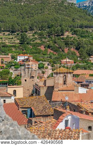 Roofs Of Old Houses With A Church Tower At Pratdip, Catalunya Spain. Background Forest At The Mounta