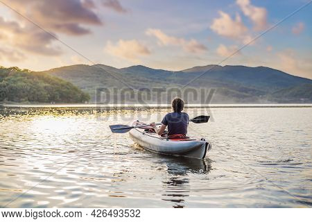 Summer Travel Kayaking. Man Paddling Transparent Canoe Kayak, Enjoying Recreational Sporting Activit