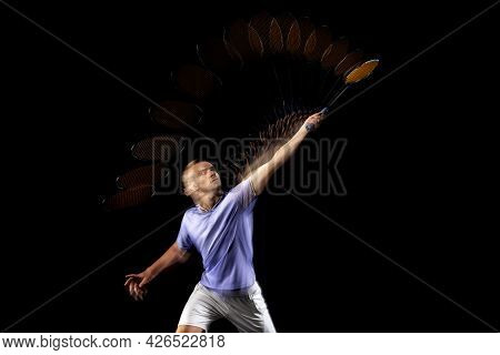 Portrait Of Young Man, Male Badminton Player, Shuttler In Motion And Action On Dark Background. Stro