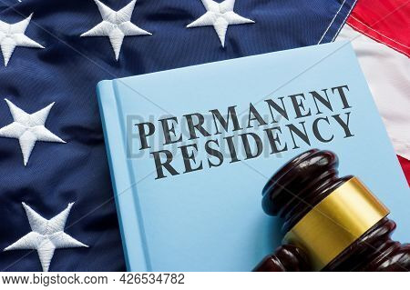 Permanent Residency Law Book On The Flag.
