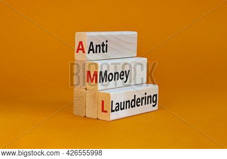 Aml, Anti-money Laundering Symbol. Wooden Blocks With Words Aml, Anti-money Laundering On Beautiful 