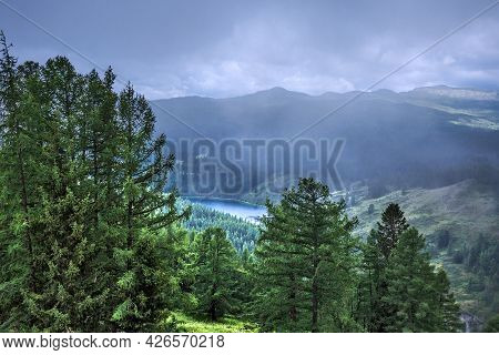 Mountain Lake Uchkel Is Surrounded By Mountains And Coniferous Taiga. Ulagan District Of The Altai R