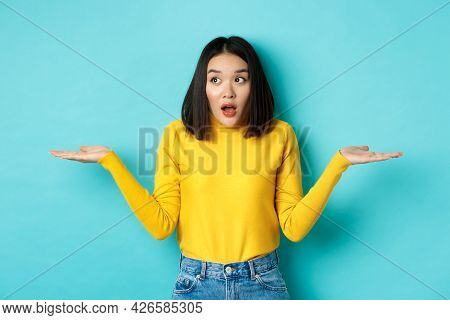 Confused And Shocked Asian Woman Dont Understand, Shrugging With Spread Hands, Gasping And Looking L