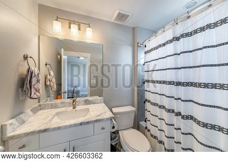 Small Bathroom Inside A Room With Ambient Lightnings And Bathtub