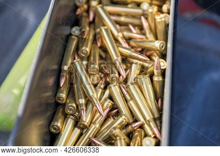 Loads Of Long Sharp Bullets Inside Its Case With A Blue Cloth On The Side.