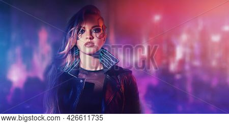 A beautiful cyberpunk girl stands against the backdrop of the night city of the future. Cyberpunk concept. Technology and fashion.