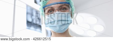 Woman Surgeon In Sterile Suit In Operating Room