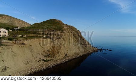 Stunning Aerial View Of The Open Sea And A Small Green Island. Shot. Breathtaking Green Grass Covere