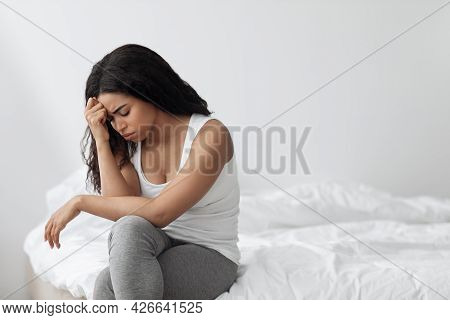 Depression Concept. Unhappy Black Lady Sitting On Bed Alone And Feeeling Upset After Breakup With Bo