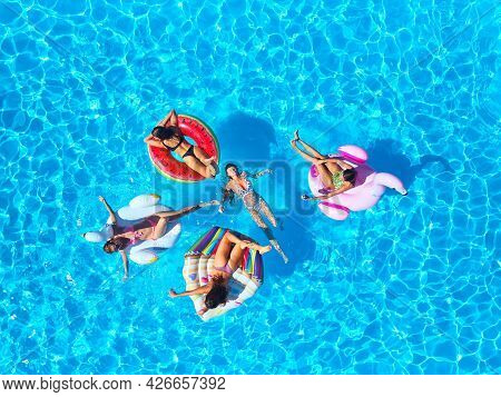 Aerial Of Hot Pretty Girls In Bikini Swimming In Pool On Floaties. Top View From Above. Attractive F