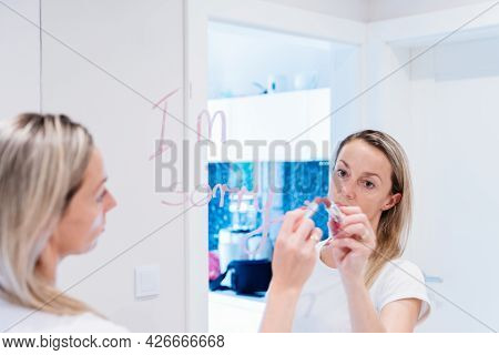 Inscription Im Sorry By Lipstick On Mirror And Reflection Of A Woman