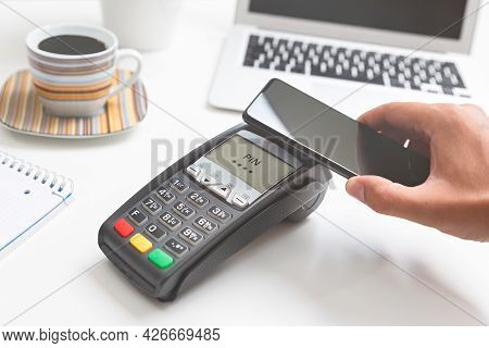 Man Pays By A Smart Phone In A Cafe Restaruant. Contactless, Convenient Form Of Payment